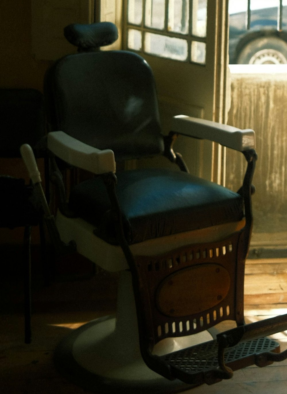 The shop door propped open onto the street, sunlight across the floor